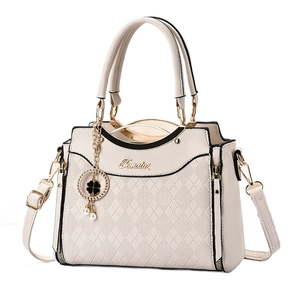 Elegant cream quilted handbag for women with clover pendant and adjustable strap