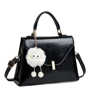 Chic black flap crossbody bag with gold buckle and a cute white plush pompom charm