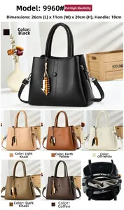 Detail of lychee textured PU leather handbag with beaded charm and multi-compartment interior