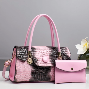 Detailed view of pink crocodile and python pattern handbags with gold hardware shell charm