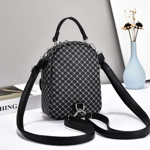 Detail of checkered pattern mini backpack with silver metal zippers and faux leather straps
