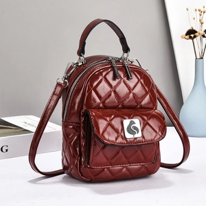 Burgundy checkered leather backpack with bird metal logo and adjustable silver straps
