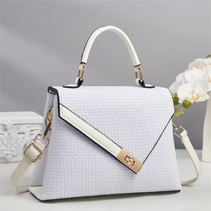 Close-up of white embossed square pattern leather bag with golden metal twist lock