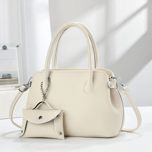 Close-up of minimalist beige lychee grain leather handbag with matching mini coin purse