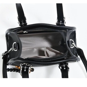 Internal view of chic black crossbody bag showing zipper pocket and spacious layout
