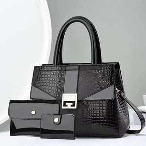 Detailed set of 3 black crocodile texture handbags with gold logo and shoulder strap