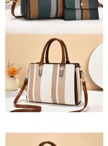 Detailed close-up of large capacity bicolor striped tote with brown handles and gold hardware