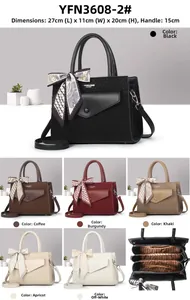 Detailed view of women handbag with dimensions 27x11x20cm and silk scarf handle decor