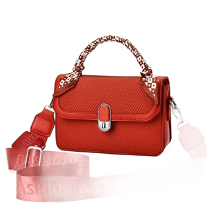 Red woven leather handbag with silver lock, floral scarf handle, and pink fabric strap