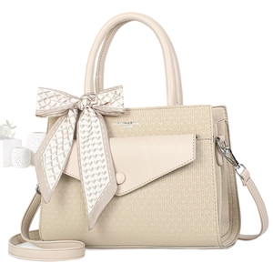 Elegant beige textured handbag with silk scarf handle and adjustable strap on white base