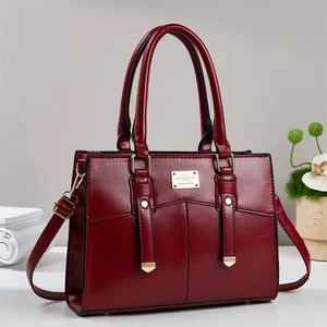 Elegant wine red PU leather handbag with gold hardware and adjustable shoulder strap