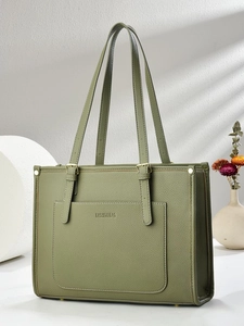 Close-up of dark green lychee grain leather tote bag featuring gold hardware and embossed logo