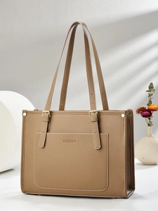 Brown lychee leather tote bag with adjustable handles and elegant minimalist design