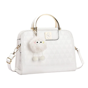 Glossy white quilted handbag with gold metal handle and furry charm decoration