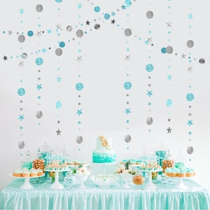 Blue and silver star and circle garland hanging above a festive dessert table setup