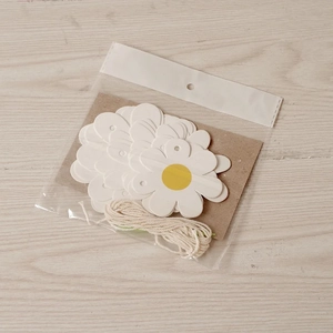 White daisy flower banner set with paper petals and twine for birthday party decoration