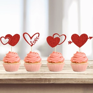 Set of 4 red glitter heart cupcake toppers with love text for romantic party cakes