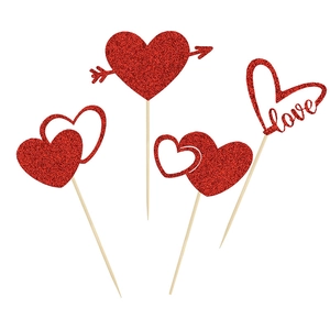 Detail of red glitter heart cake toppers including love text and cupid arrow designs