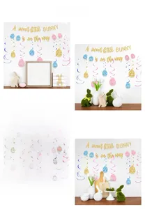 Detail of bunny party banner and colorful egg spiral hanging decorations in living room