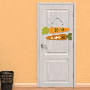 Easter carrot wood door sign with 'I DO NOT carrot ALL' pun hanging on white door