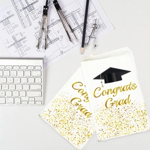 White graduation gift bags with gold Congrats Grad text and black mortarboard icon