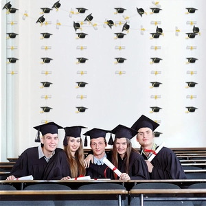 Graduation party banner with black doctoral caps and white diploma scrolls for ceremony decor