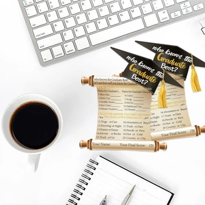 2026 graduation party game cards set featuring graduation cap design on desk with coffee