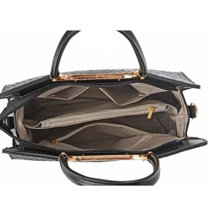 Top view of black leather handbag with three large compartments and golden hardware detail