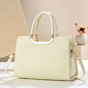 Elegant off-white woven textured handbag with gold metal handle and shoulder strap