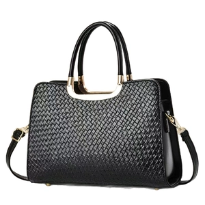 Elegant black woven leather handbag with gold metal hardware and detachable strap