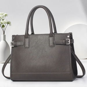 Detail of grey pebbled leather tote bag with silver hardware and adjustable side straps