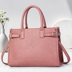 Pink leather tote bag with top handles and adjustable shoulder strap for women