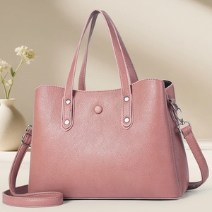 Pink lychee grain leather tote bag with silver metal ring and adjustable strap detail