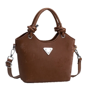 Minimalist dark brown bucket bag with knotted handles and triangular metal plate
