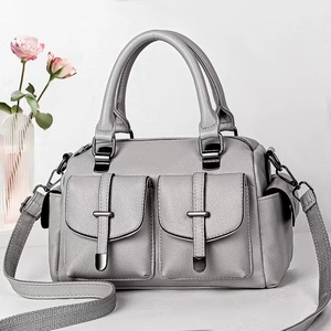 Gray lychee textured Boston bag with dual front pockets and wide woven shoulder strap