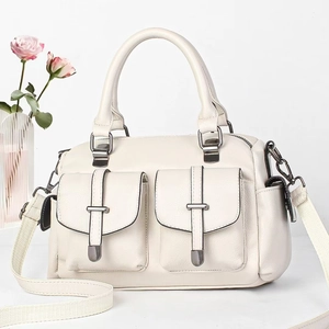 Detail of off-white lychee texture bag with dual pockets and woven shoulder strap