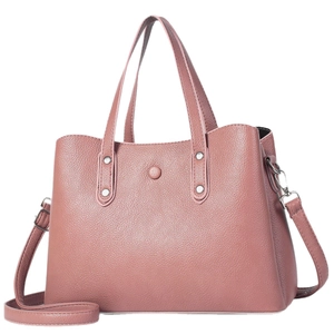 Chic rose pink faux leather handbag with silver studs and adjustable crossbody strap