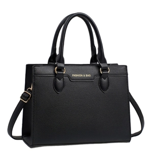 Minimalist black lychee texture tote bag with golden hardware and adjustable strap