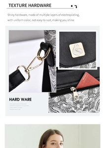 Detail of premium electroplated metal hardware and embroidered fabric on women's handbag