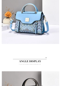 Detail view of sky blue handbag with mountain cloud embroidery and metal bird clasp