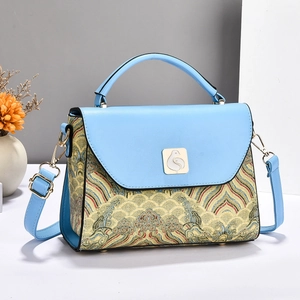 Sky blue crossbody bag with Chinese traditional embroidery and gold bird metal clasp