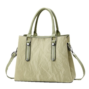 Women's pleated pistachio green tote bag with silver hardware and detachable strap