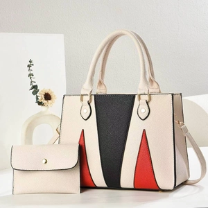 Macro detail of tricolor patchwork leather tote bag with matching small coin purse pouch