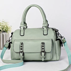 Mint green leather Boston bag with crossbody strap and rivet details for women
