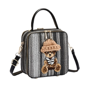 Ethnic style crossbody bag with embroidered teddy bear patch and woven texture pattern