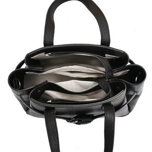 Top-down close-up showing the multi-compartment interior and herringbone lining of this black tote