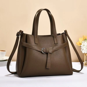 Deep brown lychee pattern leather handbag with silver hardware and adjustable shoulder strap