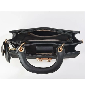 Detailed interior view of a black leather handbag featuring a three-compartment structure