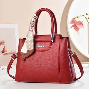 Elegant deep red leather tote bag with silk scarf handle and adjustable shoulder strap