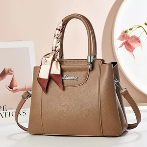 Elegant brown lychee leather handbag with silver logo and decorative silk scarf